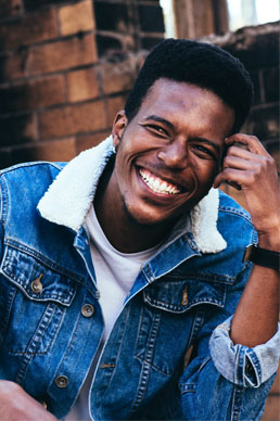 Man Smiling after getting dental bonds at kind dental